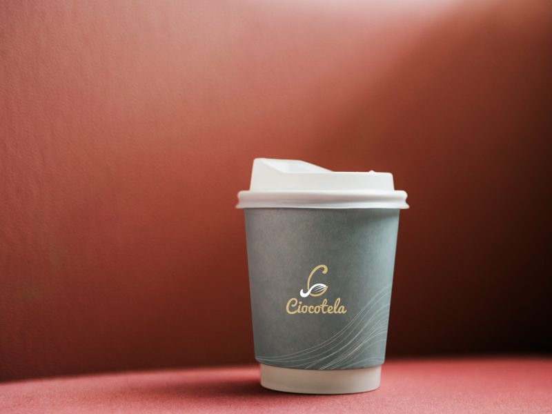 Coffee cup mockup in a red backdrop Coffee cup mockup in a red backdrop